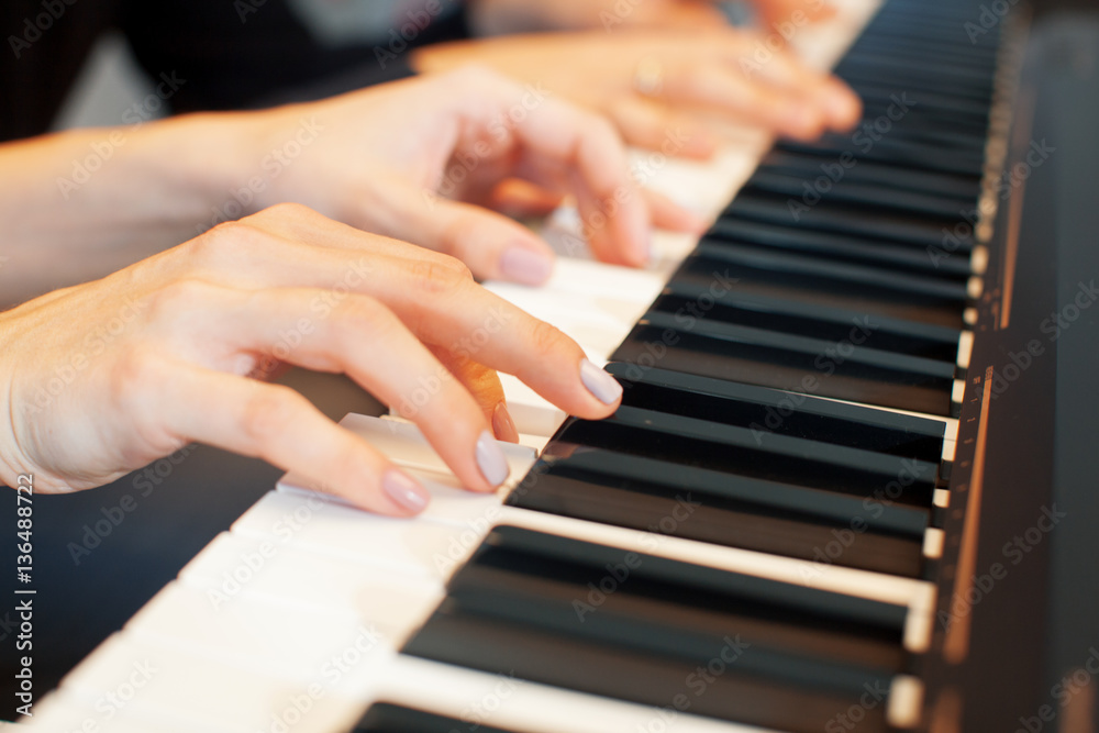 Fototapeta premium Closeup of hands playing piano. Music and hobby concept