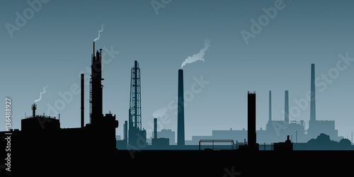 A silhouette of a heavy industrial area with smokestacks and factories.