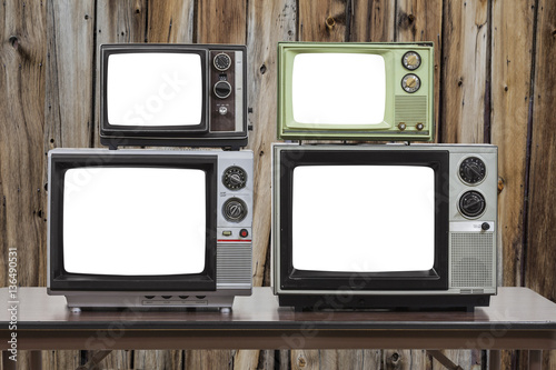 Four Vintage Televisions With Cut Out Screens and Old Wood Wall