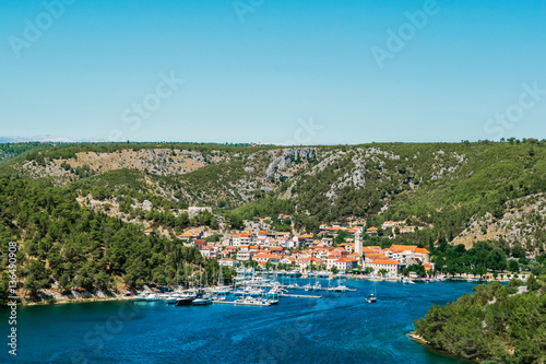 Fototapeta Naklejka Na Ścianę i Meble -  Town of Skradin on Krka river in Dalmatia, Croatia viewed from distance. Skradin is a small historic town and harbour
