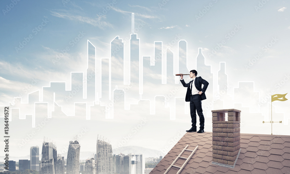 Engineer man standing on roof and looking in spyglass. Mixed med Engineer man standing on roof and looking in spyglass. Mixed med