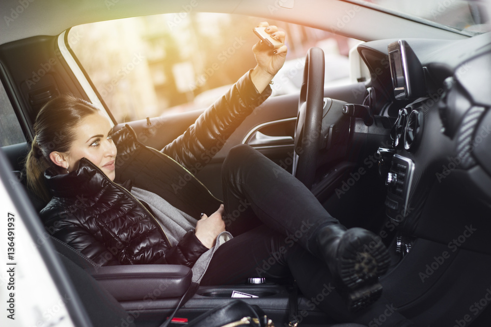 Selfie time. Woman taking a selfie in her car. Beautiful smiling woman ...