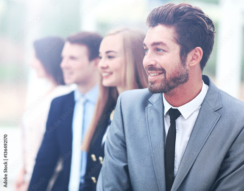 group of business people smiling in an office group of business people smiling in an office