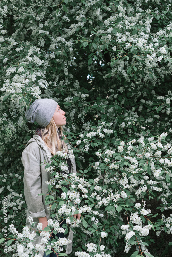 Blonde girl in a spring garden