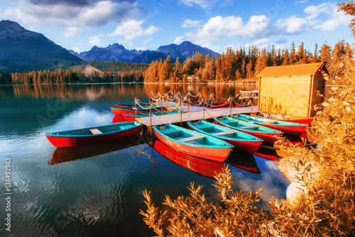 Boat on the dock surrounded mountains. Fantastic Shtrbske Pleso 