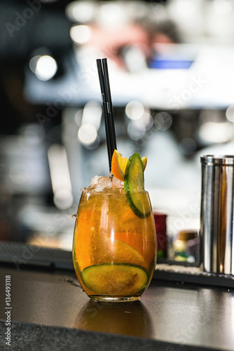 refreshing coctail with cucumber isolated on a bar background photo