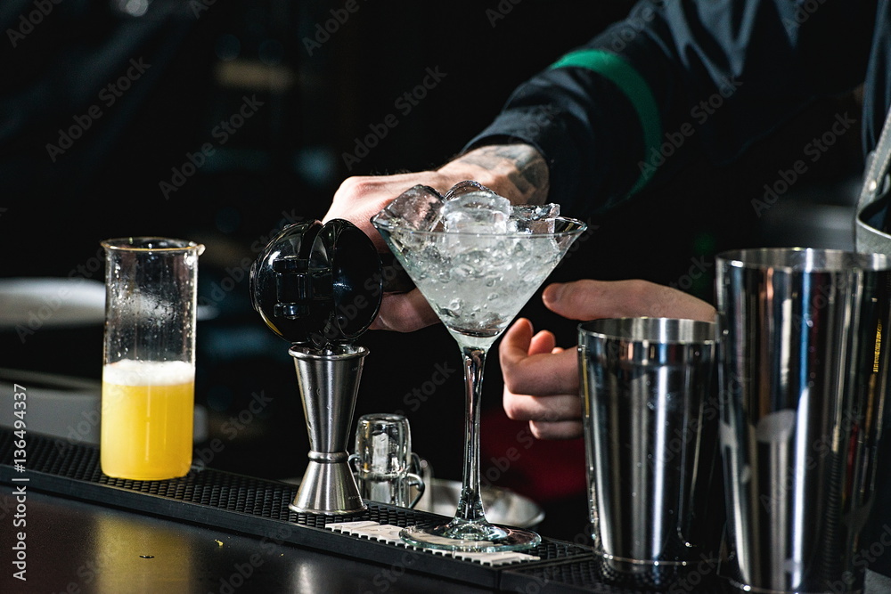 bartender making relaxing coctail on a bar background