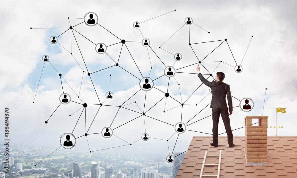 Businessman on house roof presenting networking and connection concept. Mixed media