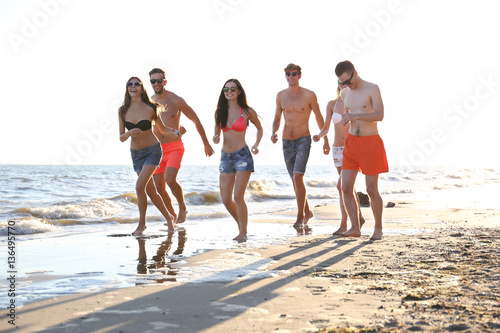 Happy friends running on beach