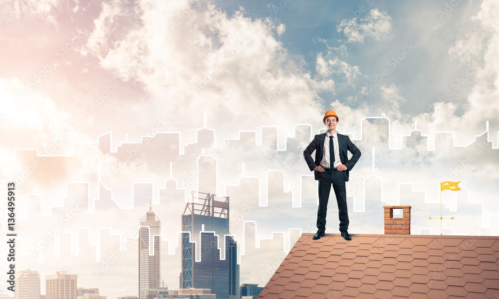 Engineer man standing on roof and looking away. Mixed media Engineer man standing on roof and looking away. Mixed media