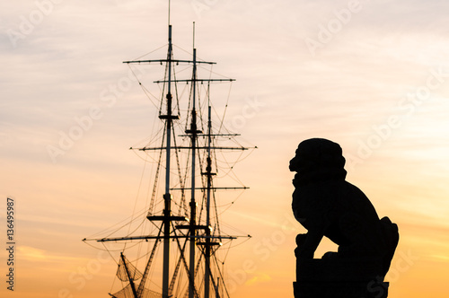 Silhouette Shih tsza and ship masts on Peter embankment. St. Petersburg. Russia
