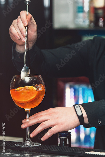 bartender makimg orange margareta fresh Cocktail in bar photo