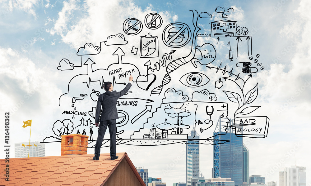 Rear view of businessman on house roof drawing his new business Rear view of businessman on house roof drawing his new business