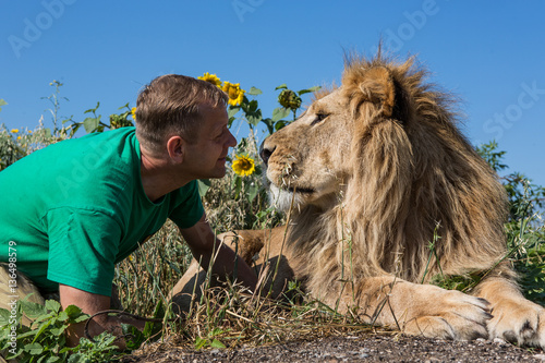 The man kissing the lion in safari park Taigan, Crimea, Russia