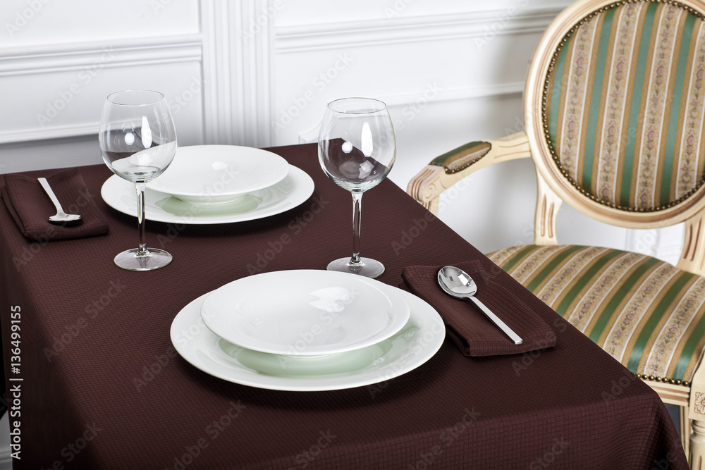 Beautiful decorated table with linen napkins, cutlery on luxurious tablecloth
