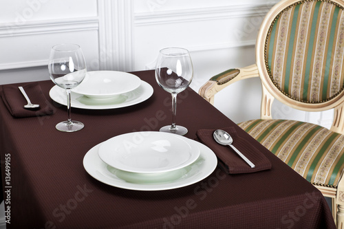 Beautiful decorated table with linen napkins, cutlery on luxurious tablecloth 