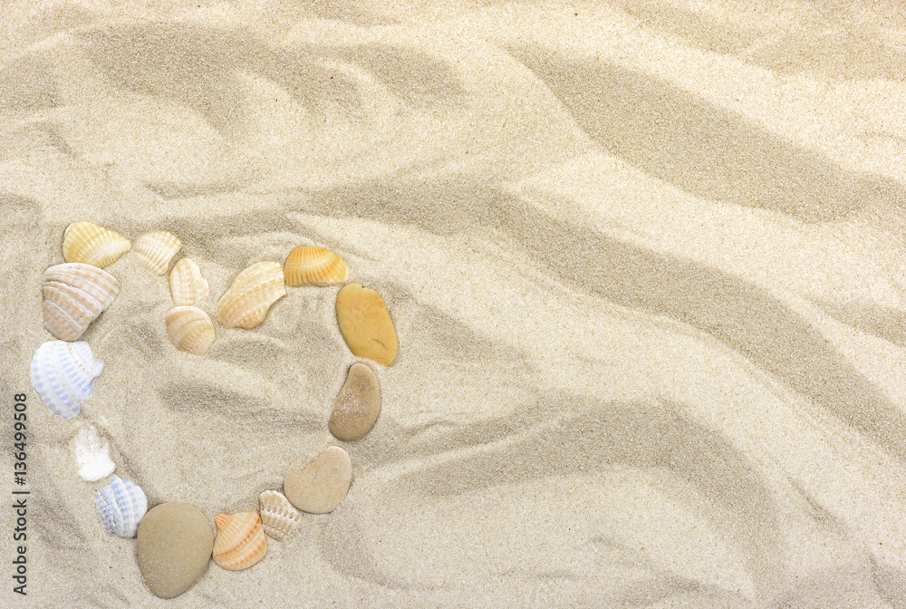 Heart on Sea Sand from pebbles and shells for background Heart on Sea Sand from pebbles and shells for background