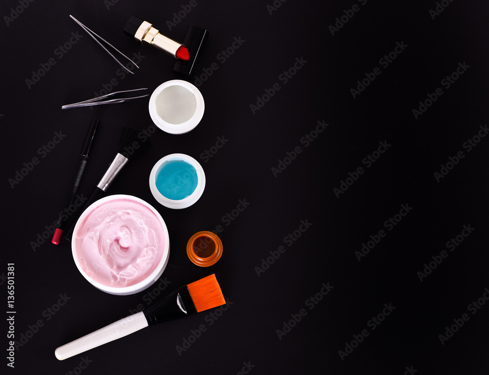 various cosmetics: cream, gel, lipstick, lip liner, brushes and tweezers various cosmetics: cream, gel, lipstick, lip liner, brushes and tweezers