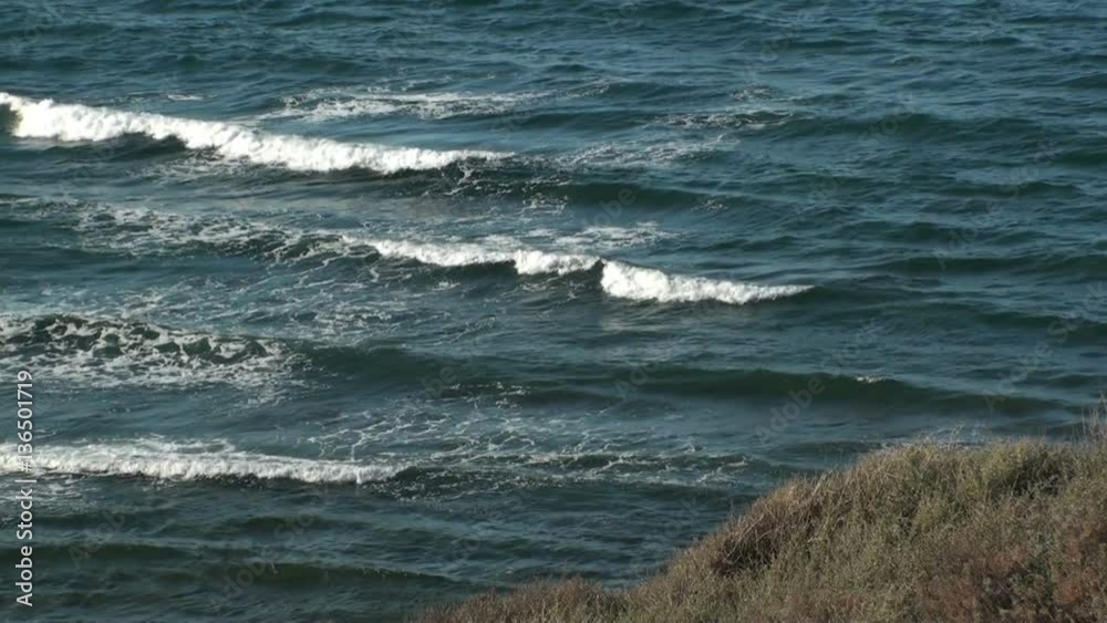 Coastline with embankments and approaching waves in sardinia, italy Coastline with embankments and approaching waves in sardinia, italy