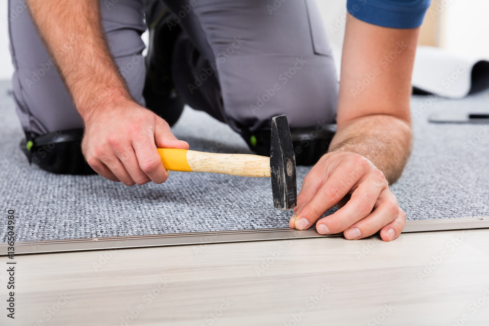 Person's Hand Using Hammer And Nail Person's Hand Using Hammer And Nail