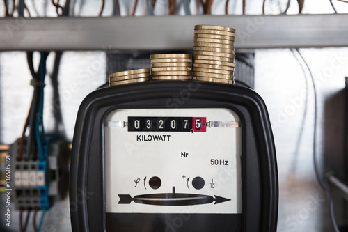 Stacked Coin On Kilowatt Meter photo