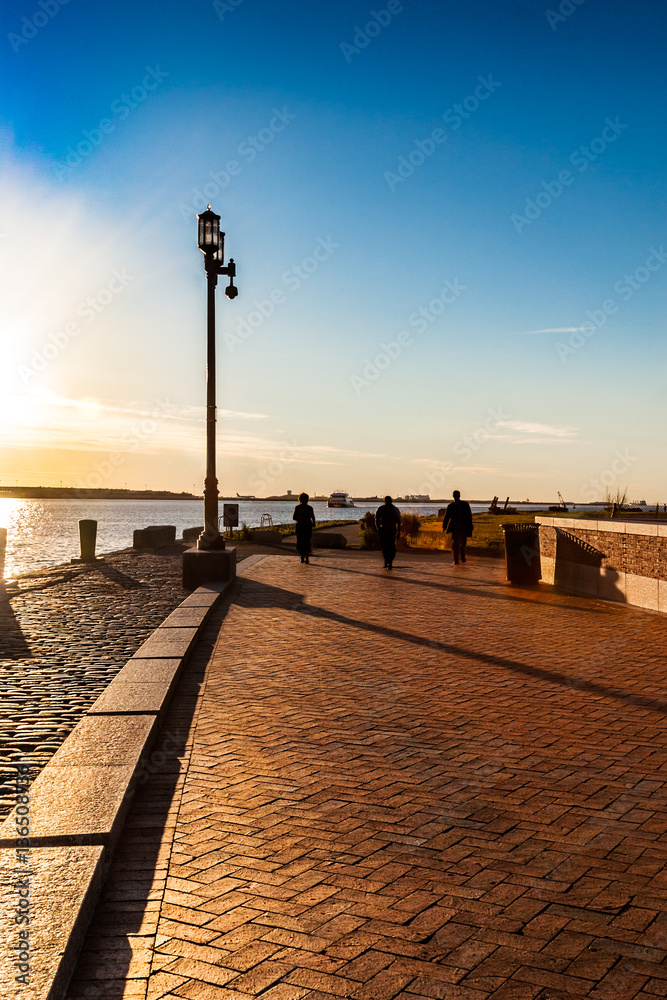 Morning sun on Boston's Harborwalk which stretches over 30 miles around the waterfront and downtown, used by tourists and commuters
