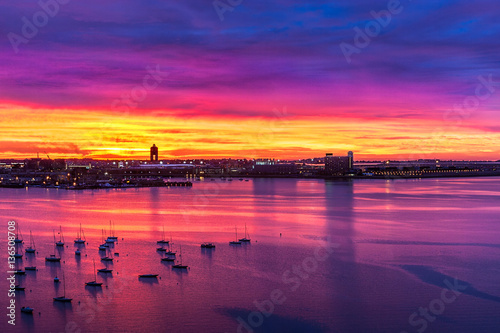 Vivid skies before sunrise with boats at anchor in Boston harbor  photo