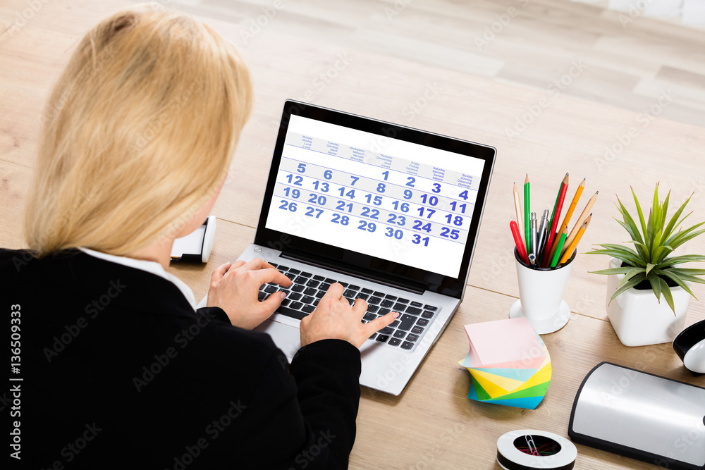© Andrey Popov - Businesswoman Looking At Calendar On Laptop © Andrey Popov - Businesswoman Looking At Calendar On Laptop