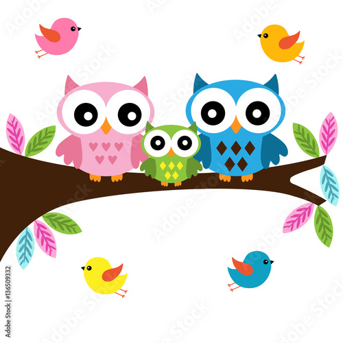 Owls family sitting on a branch