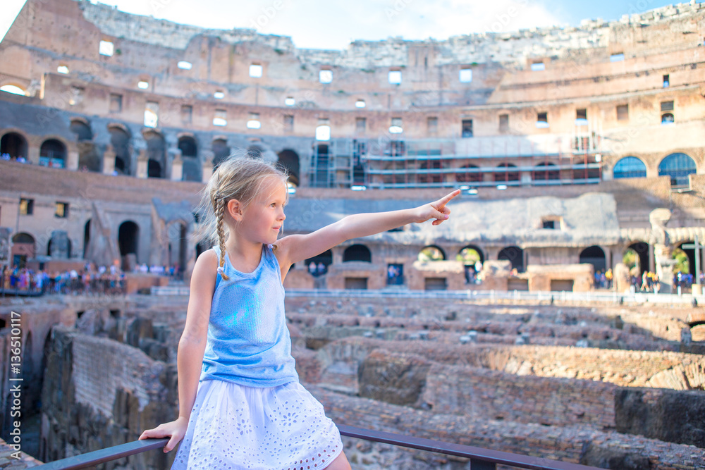 Little girl in Coliseum, Rome, Italy. Cute kid looking at famous places in Europe