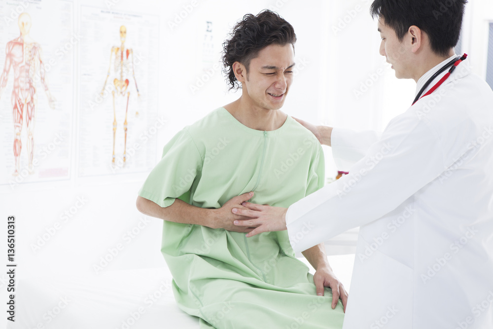 A man is visiting a hospital with stomach pain