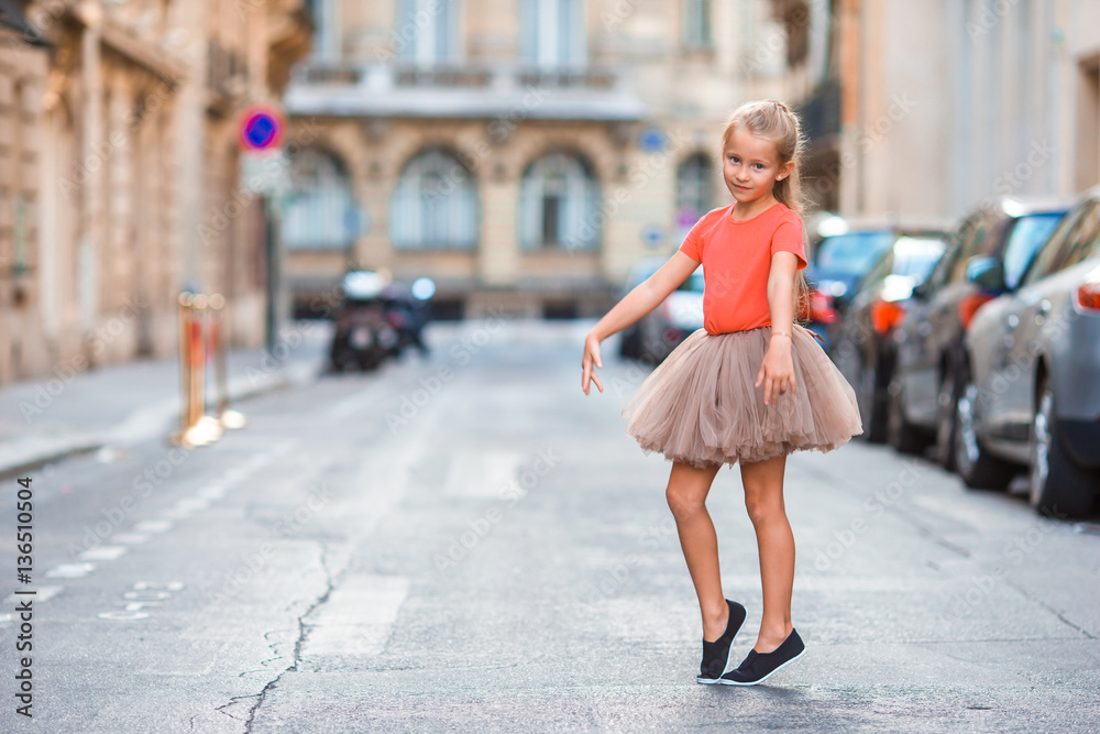 Adorable little girl during summer vacation in Paris. Amazing balerina enjoy her trip in France