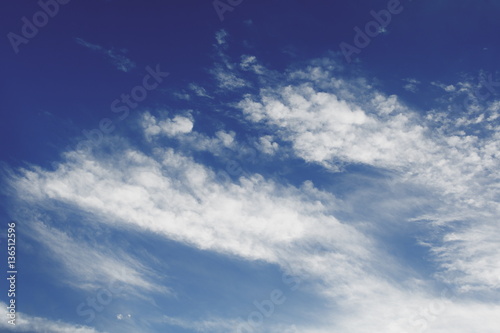 Blue sky with white fluffy cloud background
