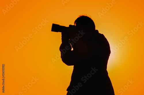 silhouette photographer with sunset 