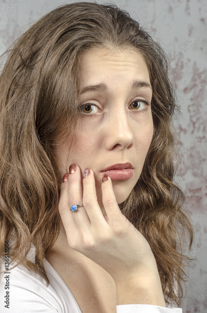 Portrait of a young brown-haired woman with a romantic curly hair in a white blouse
Portrait of a young brown-haired woman with a romantic curly hair in a white blouse