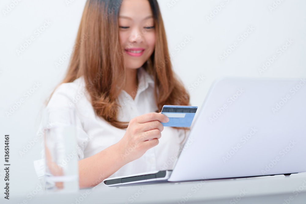 Paying online and E-bank concept.Asian Chinese young business woman using credit card paying online with laptop. Paying online and E-bank concept.Asian Chinese young business woman using credit card paying online with laptop.