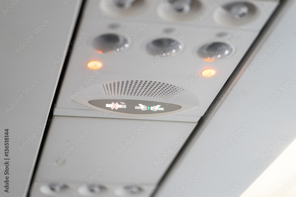 Overhead electronic device inside airplane Overhead electronic device inside airplane