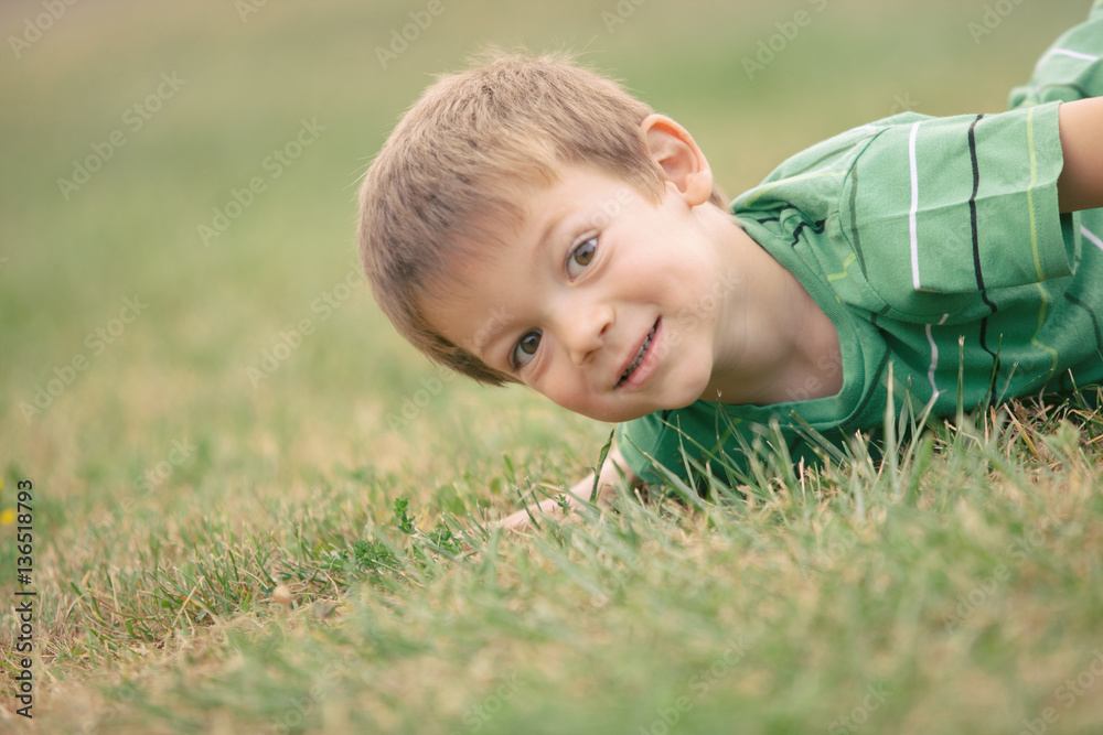 happy smiling blond caucasian kid outdoor portrait at park happy smiling blond caucasian kid outdoor portrait at park