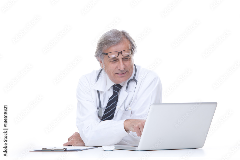 happy senior doctor with stethoscope working with laptop isolated on white happy senior doctor with stethoscope working with laptop isolated on white