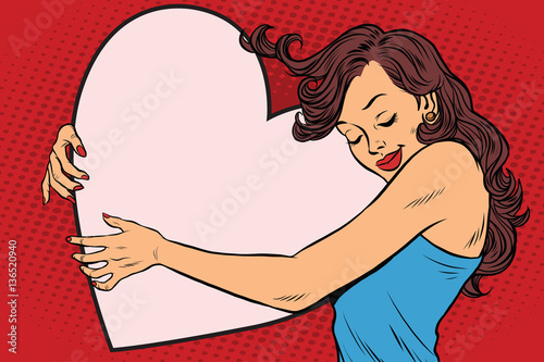 Beautiful young woman hugging Valentine heart