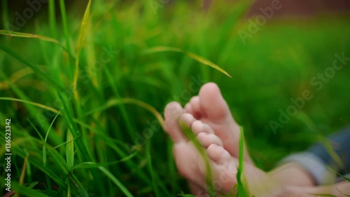 bare feet on green grass, copy space 4k 20s. photo