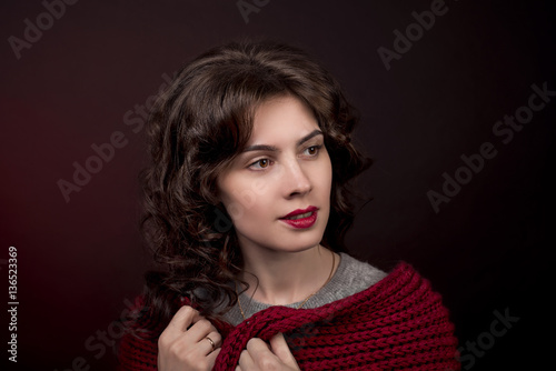 close-up portrait of girl with curly hair from a dark red scarf