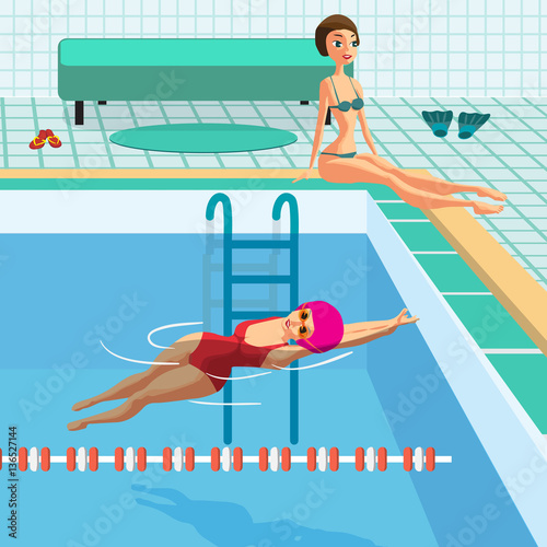 Public swimming pool inside with blue water. Young women in spor