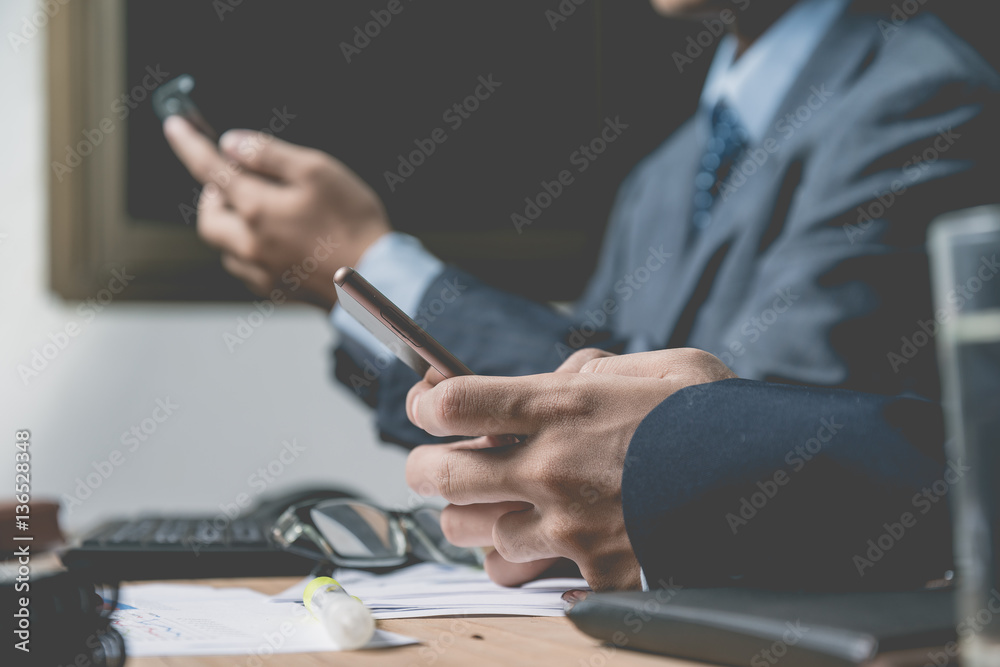 Fototapeta premium business documents on office table with laptop computer and man working in the background