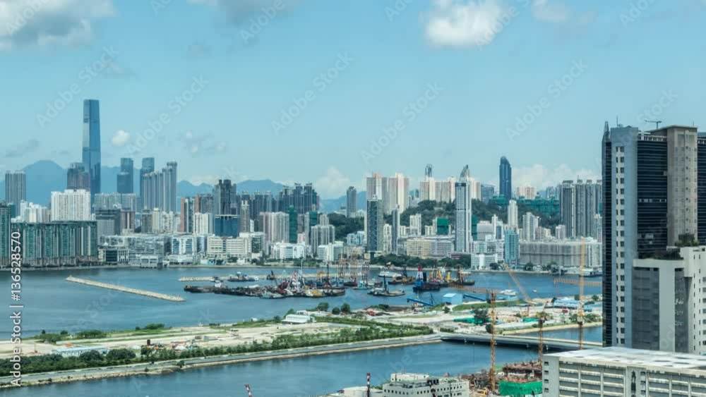 Timelapse Top View of Hong Kong Cityscape day whit clouds, skyline of the city near Kowloon Bay with ships and cars in freeway front the Harbour -Dan Timelapse Top View of Hong Kong Cityscape day whit clouds, skyline of the city near Kowloon Bay with ships and cars in freeway front the Harbour -Dan