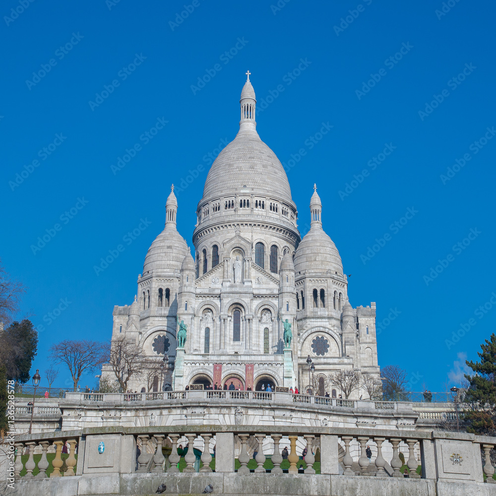 Paris, basilica Sacre-Coeur, touristic monument in blue sky