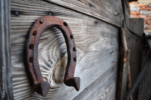 Fototapeta Naklejka Na Ścianę i Meble -  Old rusty horseshoe on a wooden background