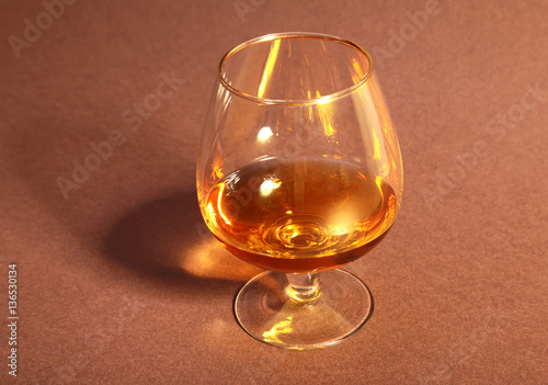 cognac in a glasses, pralines on Old textile sacking