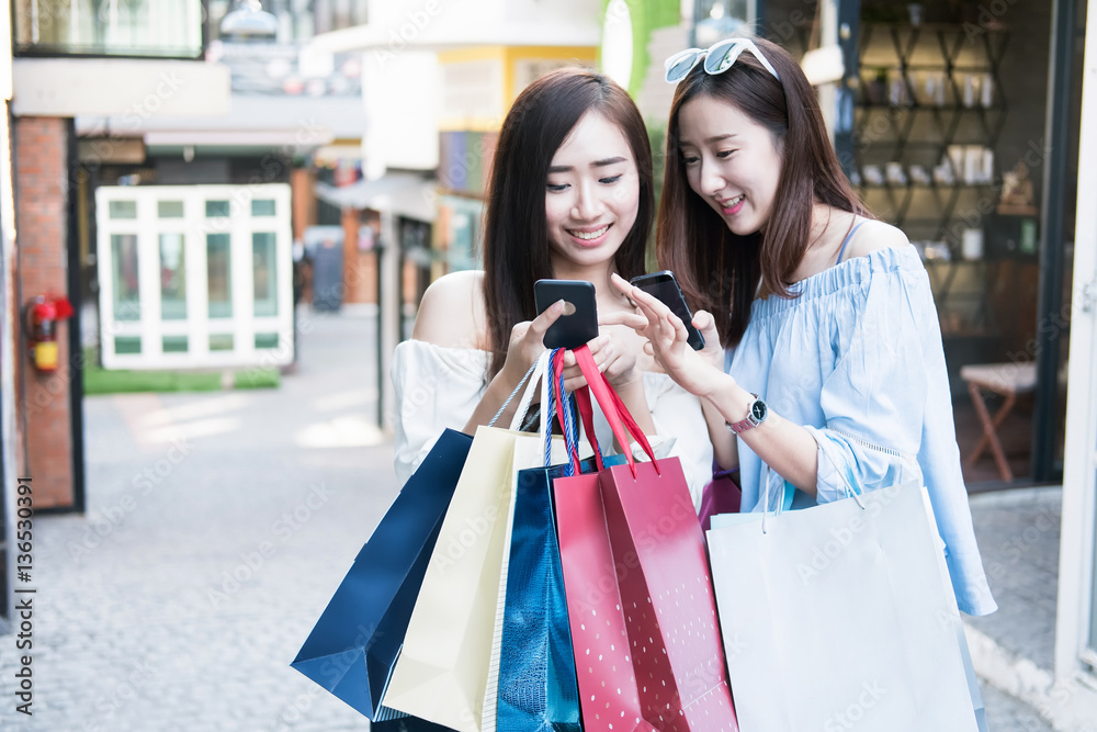 two young happy asian women shopping outdoor shopping mall in a two young happy asian women shopping outdoor shopping mall in a