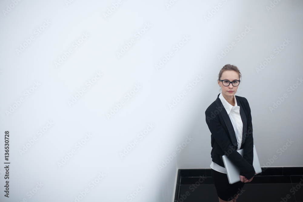 Young business woman using laptop in the office. Young business woman using laptop in the office.
